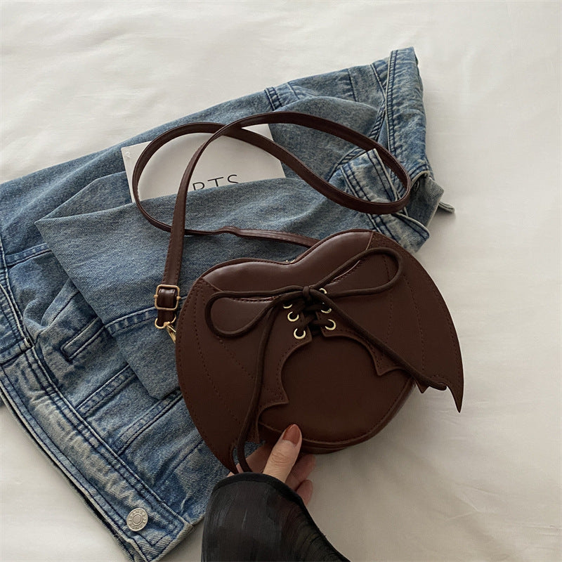Brown handbag with a bow on a denim jacket