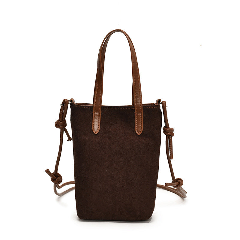 Brown leather handbag with drawstring on a white background