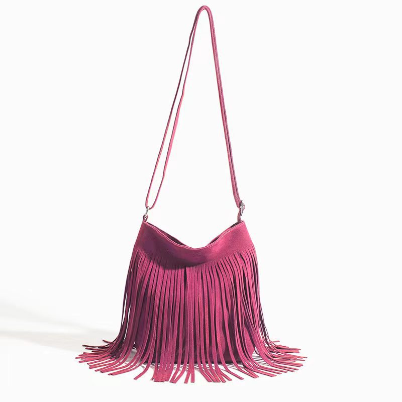 Pink fringe handbag on a white background