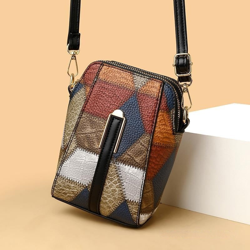 Patchwork patterned handbag with a black strap on a beige background
