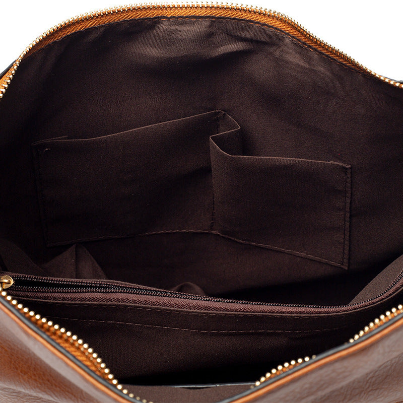 soft PU leather shoulder tote featuring zipper closure and multiple interior storage pockets